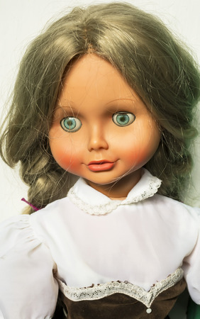 Portrait Of A Doll With Blond Hair Blue Eyes Dressed In Laced