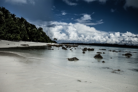 Transparent sea water and blue sky with clouds の写真素材
