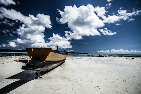Yellow boat on a beach. ( HDR image )の写真素材