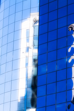 Blue sky reflected in the glass building.の写真素材