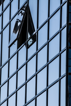 Blue sky reflected in the glass building.の写真素材