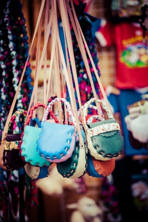 bags hanging at outdoor market の写真素材