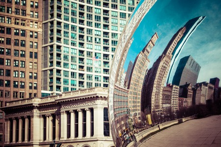 CHICAGO, IL - APRIL 2: Cloud Gate and Chicago skyline on April 2, 2014 in Chicago, Illinois. Cloud Gate is the artwork of Anish Kapoor as the famous landmark of Chicago in Millennium Park.のeditorial素材