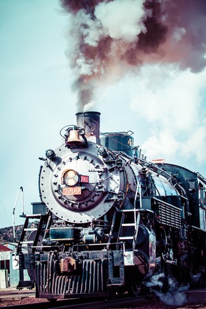 Old steam locomotive against blue cloudy sky, vintage train のeditorial素材