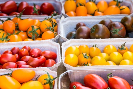 small tomatoes on display at the farmers market の写真素材