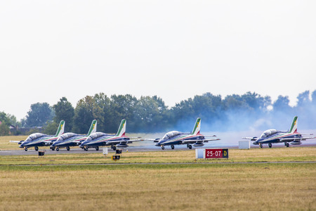 RADOM, POLAND - AUGUST 23: Aerobatic group formation "Frecce Tricolori" italian aerobatic Team at blue sky during Air Show Radom 2015 event on August 23, 2015 in Radom, Polandのeditorial素材