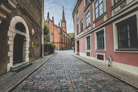 Morning street in medieval town of old Riga city, Latvia. Walking through medieval streets of old Riga, tourists can find unique architectural ensembles and ancient housesのeditorial素材