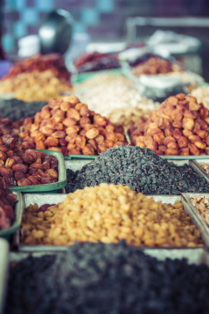 Dry fruits and spices like cashews, raisins, cloves, anise, etc. on display for sale in a bazaar in Osh Kyrgyzstan.の写真素材
