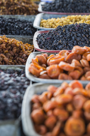 Dry fruits and spices like cashews, raisins, cloves, anise, etc. on display for sale in a bazaar in Osh Kyrgyzstan.の写真素材