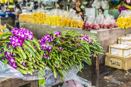 Bouquets of purple and white orchid flowers stacked on display at flower market in Bangkok, Thailandの写真素材
