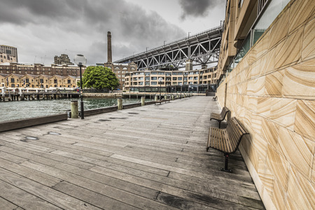 SYDNEY - OCTOBER 25:Ccircular Quay waterfront,  piers at cloudy day view towards harbour bridge,...