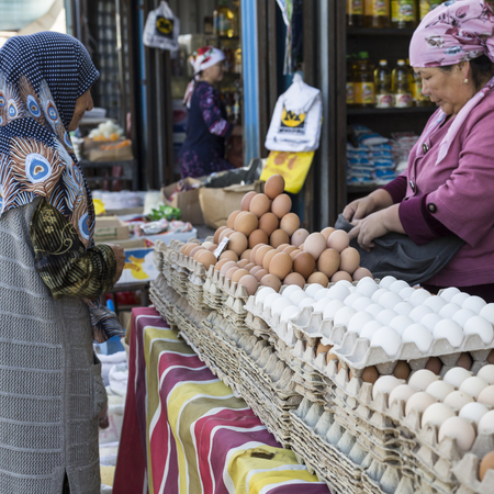 BISHKEK, KYRGYZSTAN - SEPTEMBER 27, 2015 : Woman selling eggs in local market.のeditorial素材