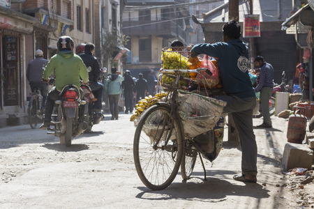 KATHMANDU, NEPAL - FEBRUARY 10, 2015: The streets of Kathmandu, Nepal, near Dubar square. Masses of people, rickshaws and Motorbikes crowd through the streets, 10, 2015 in Kathmandu, Nepal.のeditorial素材