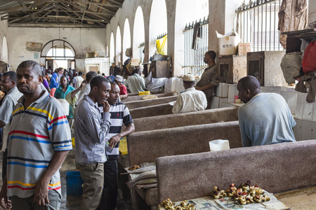 STONE TOWN, ZANZIBAR - JANUARY 15: Sellers offer fresh fish and seafood in the city market on 15 January 2015 in Stone Town, Tanzania.のeditorial素材