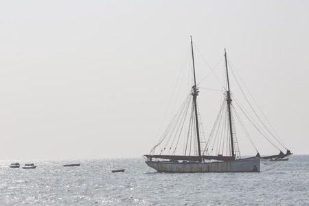 Wooden sailboat (dhow) on the clear turquoise water of Zanzibar island