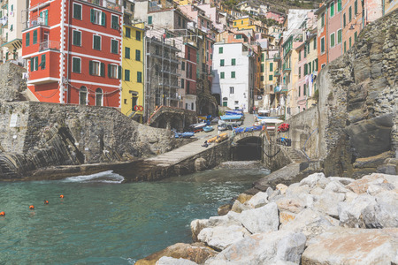 Riomaggiore fisherman village in a dramatic windy weather. Riomaggiore is one of five famous colorful villages of Cinque Terre in Italy, suspended between sea and land on sheer cliffs.のeditorial素材