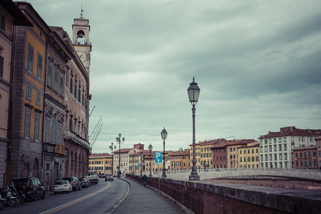 PISA, ITALY - MARCH 10, 2016: River Arno floating through the medieval city of Pisa in Italy, on March 10, 2016のeditorial素材