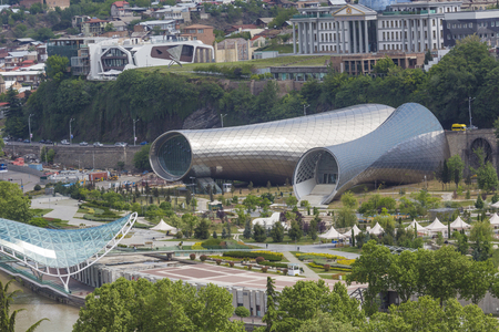 TBILISI, GEORGIA - MAY 07, 2016: People in apark in front of Concert Hall and the Official residence of Georgian President in Tbilisi, Georgiaのeditorial素材