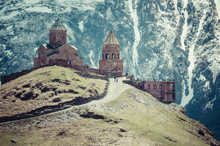 Georgia, Stepantsminda-Sameba. Ancient Gergeti Trinity Church high in the mountains.の写真素材