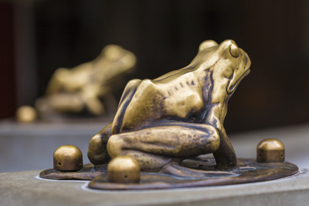 Fountain with golden lucky frog - the symbol of Torun city (Poland)の写真素材