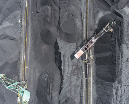 Mining excavator on the bottom surface mine. Brown coal deposits. View from above.