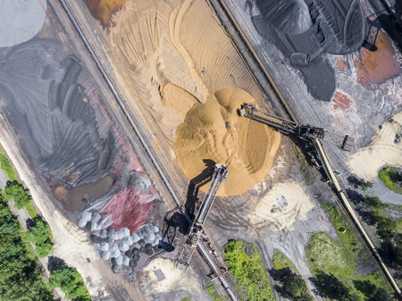 Mining excavator on the bottom surface mine. Brown coal deposits. View from above.