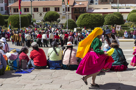 Puno, Peru - August 20, 2016: Native people from peruvian city dressed in colorful clothing perform traditional dance in a religious celebration. Peru, South America.のeditorial素材