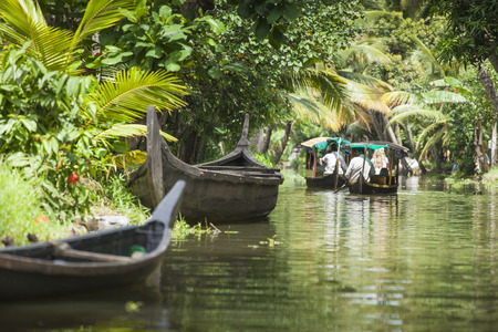 ALLEPPEY, KERALA, INDIA - AUGUST 16, 2016: Unidentified indian people in small boat in backwaters. Kerala backwaters are both major tourist attraction and integral part of local people life in Keralaのeditorial素材