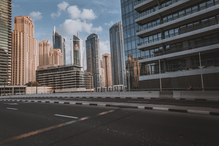 DUBAI, UAE - JANUARY 18, 2017 : Dubai downtown in the evening, luxury modern buildings in bright yellow sunrise light, futuristic cityscape of United Arab Emirates.のeditorial素材