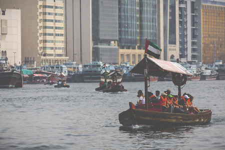 DUBAI, UAE - JANUARY 18, 2017 : Traditional water taxi boats in Dubai, UAE. Panoramic view on Creek gulf and Deira area. Famous tourist destination.のeditorial素材