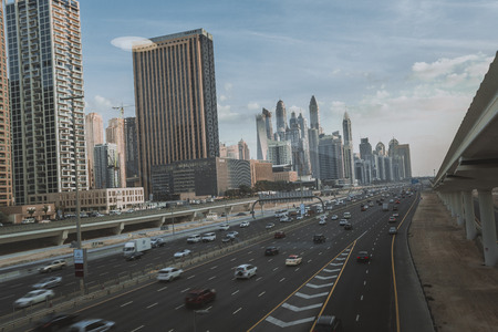 DUBAI, UAE - JANUARY 18, 2017 : Dubai downtown in the evening, luxury modern buildings in bright yellow sunrise light, futuristic cityscape of United Arab Emirates.のeditorial素材
