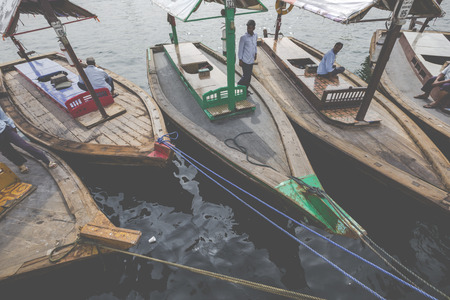 DUBAI, UAE - JANUARY 18, 2017 : Piers of traditional water taxi boats in Dubai, UAE. Panoramic view on Creek gulf and Deira area. Famous tourist destination.のeditorial素材