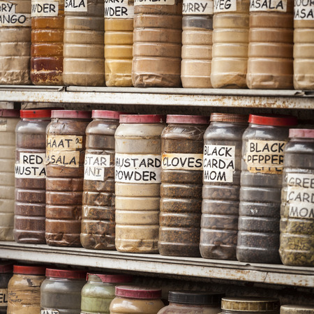 Jars of herbs and powders in a indian spice shop.の写真素材