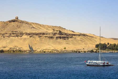 Felucca (river boat) on the Nile, with the Sahara behind in Aswan, Egipt.の写真素材