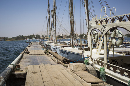 Wooden boats felucca at the Nile River in Aswan, Egypt, North Africaの写真素材