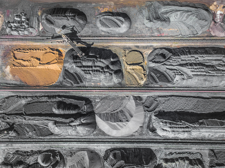 Brown coal deposits. Surface mine with exposed colored minerals and brown coal, mining equipment....