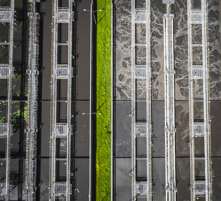 Sewage farm. Static aerial photo looking down onto the clarifying tanks and green grass. Geometric background texture.の写真素材
