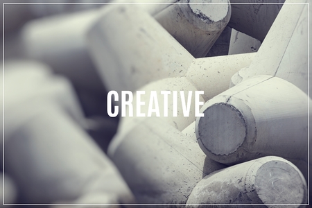 Word Creative over breakwater concrete block.