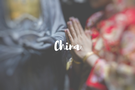 China. Woman hand respect to buddha statue.の写真素材