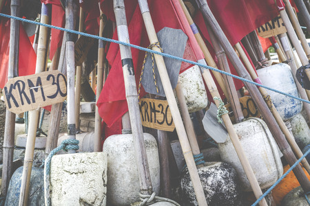 Network fishing drying on the beach in sunny day. Baltic Sea and fishing boats in background. Krynica Morska, Poland.のeditorial素材