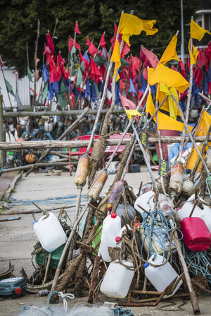 Network fishing drying on the beach in sunny day. Baltic Sea and fishing boats in background. Krynica Morska, Poland.のeditorial素材