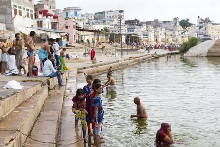 PUSHKAR, INDIA - SEPTEMBER 17, 2017: Hindu devotees pilgrims bathing in sacred Puskhar lake (Sagar) on ghats of Pushkar, Rajasthan. Pushkar is holy city for Hinduists and famous for many Hindu temples.のeditorial素材