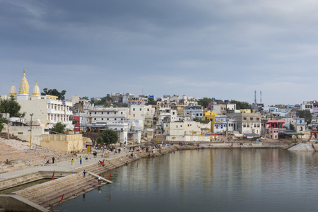 PUSHKAR, INDIA - SEPTEMBER 17, 2017: Hindu devotees pilgrims bathing in sacred Puskhar lake (Sagar) on ghats of Pushkar, Rajasthan. Pushkar is holy city for Hinduists and famous for many Hindu temples.のeditorial素材