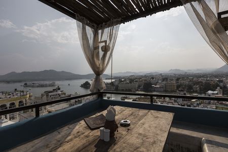 Roof top restaurant with beautiful view to Lake Pichola in the morning in Udaipur, Rajasthan, Indiaの写真素材