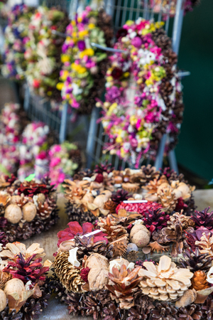 Christmas market of home made wreaths and other composition from dry flowers の写真素材