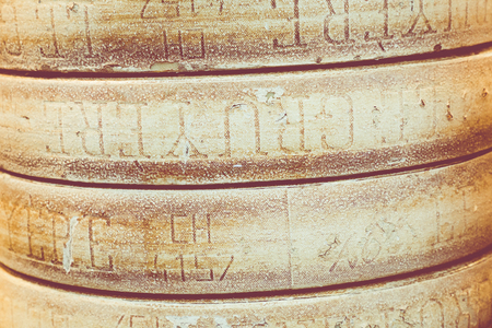 Wheels of cheese seasoned with herbs to sell on stallの写真素材