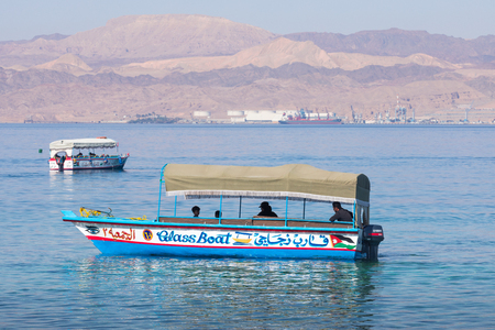 AQABA, JORDAN - MARCH 19, 2018: Touristic ships on the beach of Aqaba, Jordan. Popular resort,...