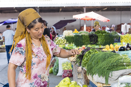 MARGILAN, UZBEKISTAN - AUGUST 24, 2018: People at local fruit and vegetables bazaar - Margilan near Fergana, Uzbekistan.のeditorial素材