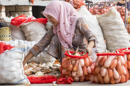MARGILAN, UZBEKISTAN - AUGUST 24, 2018: People at local fruit and vegetables bazaar - Margilan near Fergana, Uzbekistan.のeditorial素材