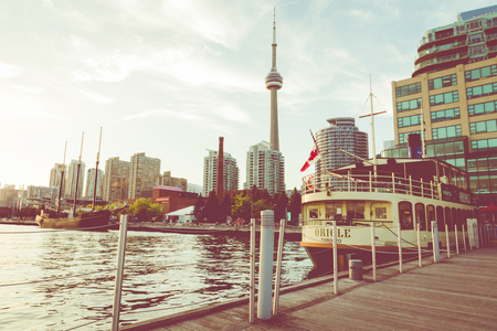 TORONTO, CANADA - SEPTEMBER 18, 2018: Sunset at the Ontario lake with tall ship standing at marina in Toronto, Canada.のeditorial素材